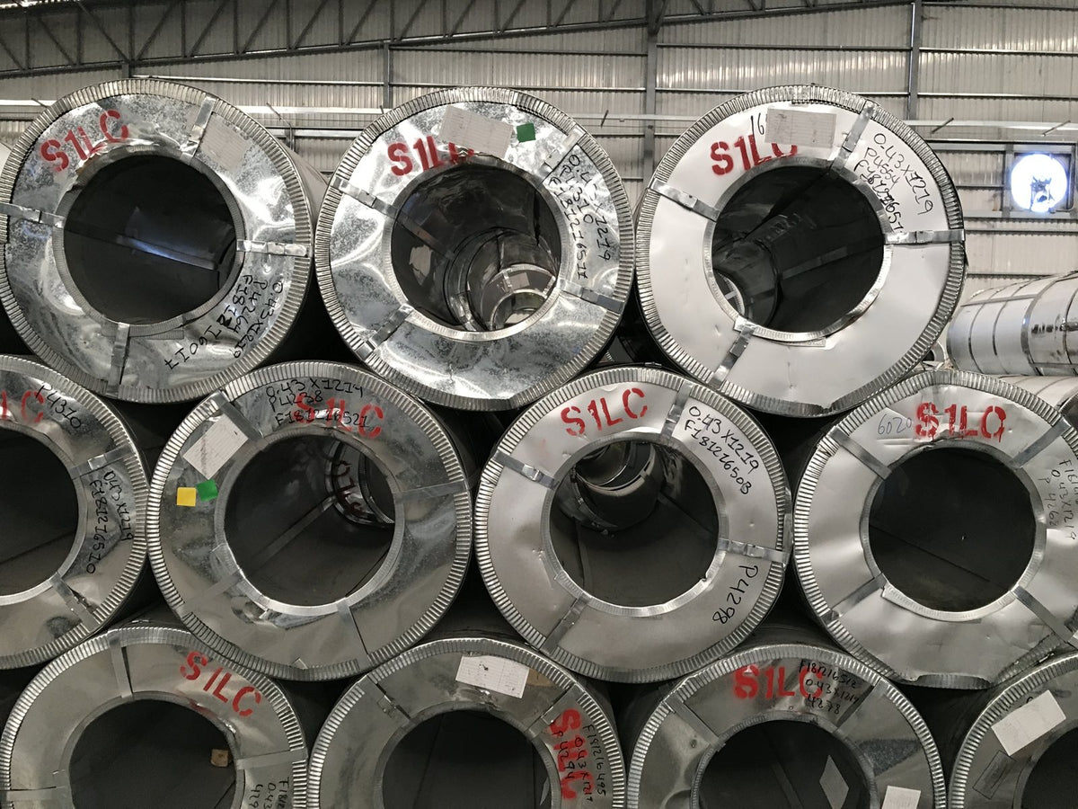 Rolled steel coils in a warehouse. The product whose Canada border tax rose to 50 percent on September 8, 2026.