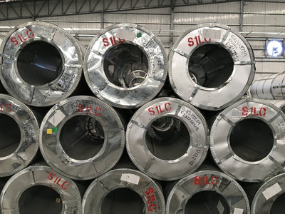 Rolled steel coils in a warehouse. The product whose Canada border tax rose to 50 percent on September 8, 2026.