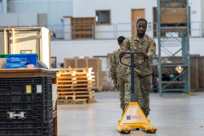 U.S. Air Force airman with yellow pallet jack in a logistics warehouse — illustrative material-handling duty context (USAF / public domain)