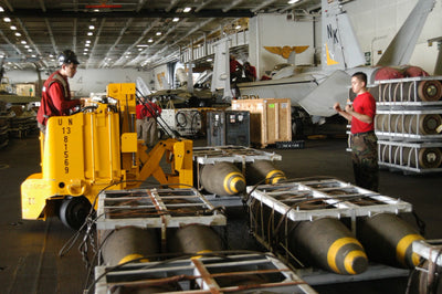 U.S. Navy electric forklift in a hangar bay, stand-in, not the Columbus factory