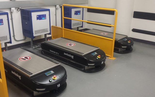 Stand-in warehouse automated guided vehicles — illustrative only, not Cummins Lindesberg or KNAPP Open Shuttle Fork hardware