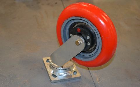 Close-up of an industrial swivel caster with shock absorber — illustrative stand-in, not a Tellure Rôta or Elesa product