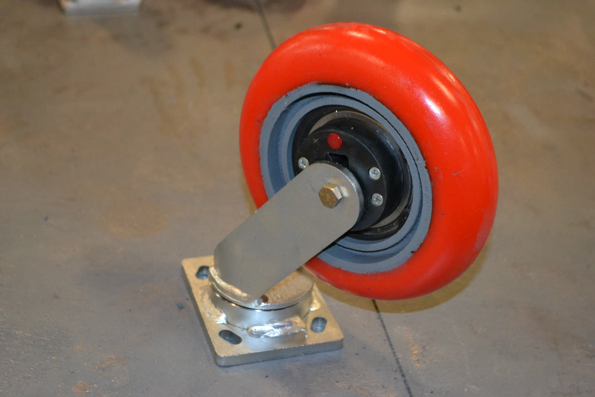 Close-up of an industrial swivel caster with shock absorber — illustrative stand-in, not a Tellure Rôta or Elesa product