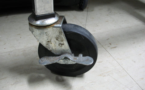 A swivel caster with a wheel lock, illustrative of the product type, not an A.U.T. wheel