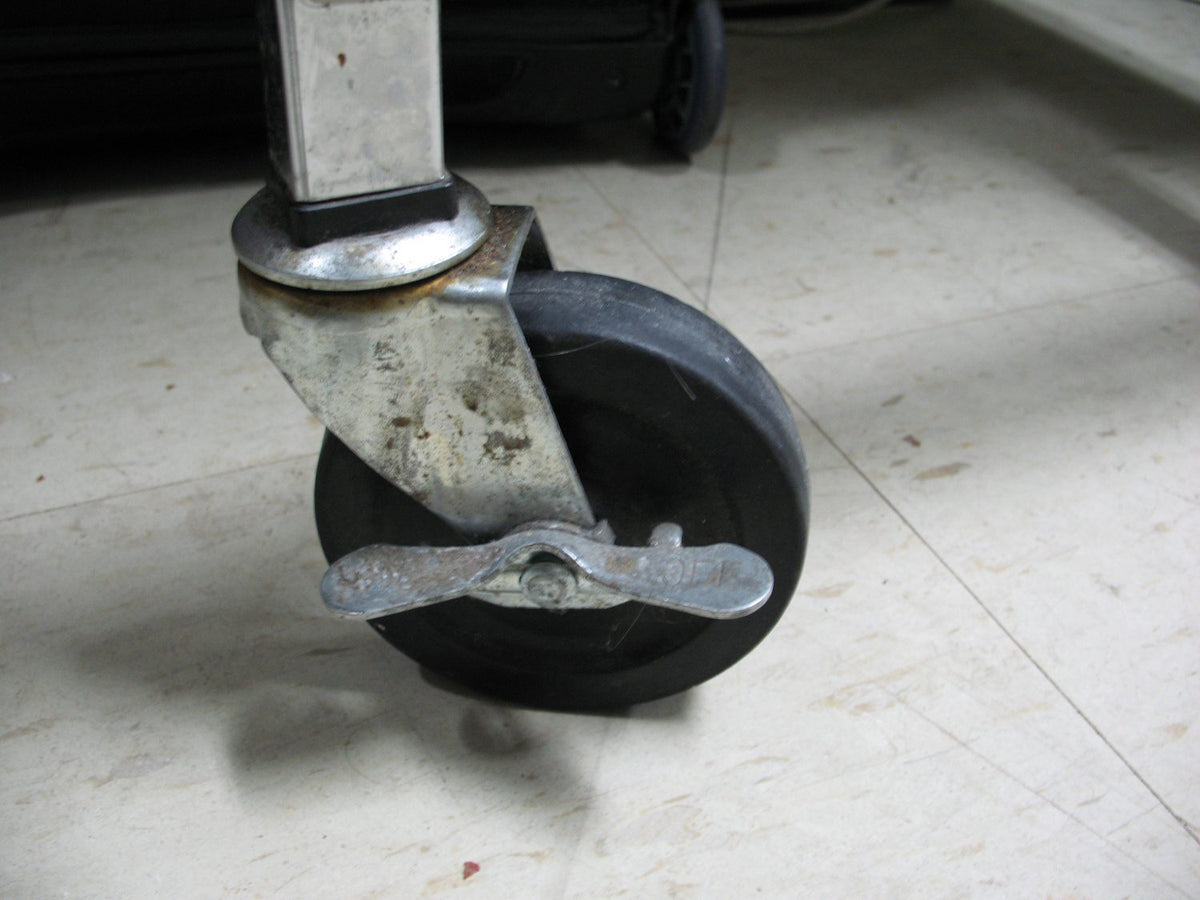 A swivel caster with a wheel lock, illustrative of the product type, not an A.U.T. wheel