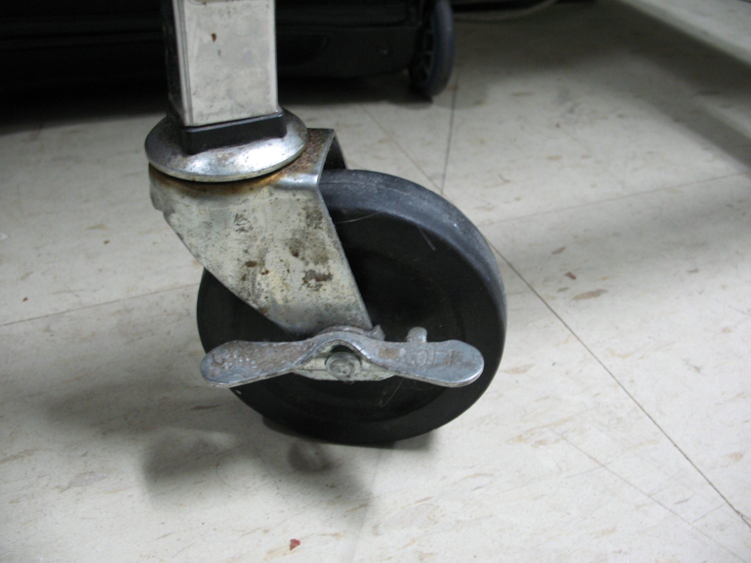 A swivel caster with a wheel lock, illustrative of the product type, not an A.U.T. wheel