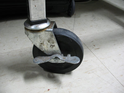 A swivel caster with a wheel lock, illustrative of the product type, not an A.U.T. wheel
