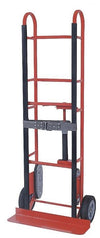 Stevens ESCORT SRT-8 steel appliance hand truck, front view: red steel frame, black vinyl uprights, strap with ratchet buckle, 8 in wheels and footplate